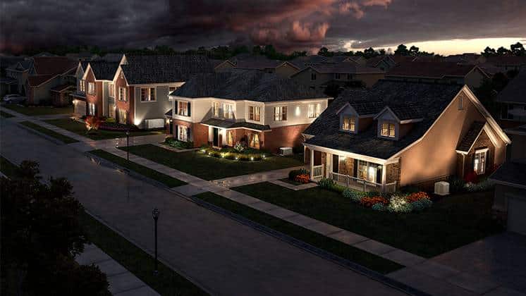 A row of suburban homes on a street int he evening with dark clouds in the background.