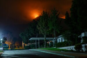 Wildfire in the distance near residential area in California.